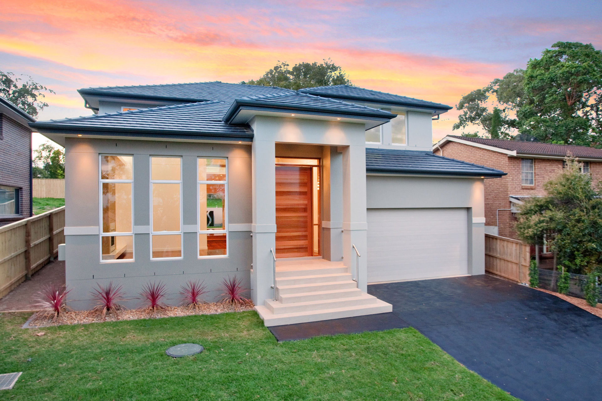 Stringybark — Rendered facade with timber entry at sunset