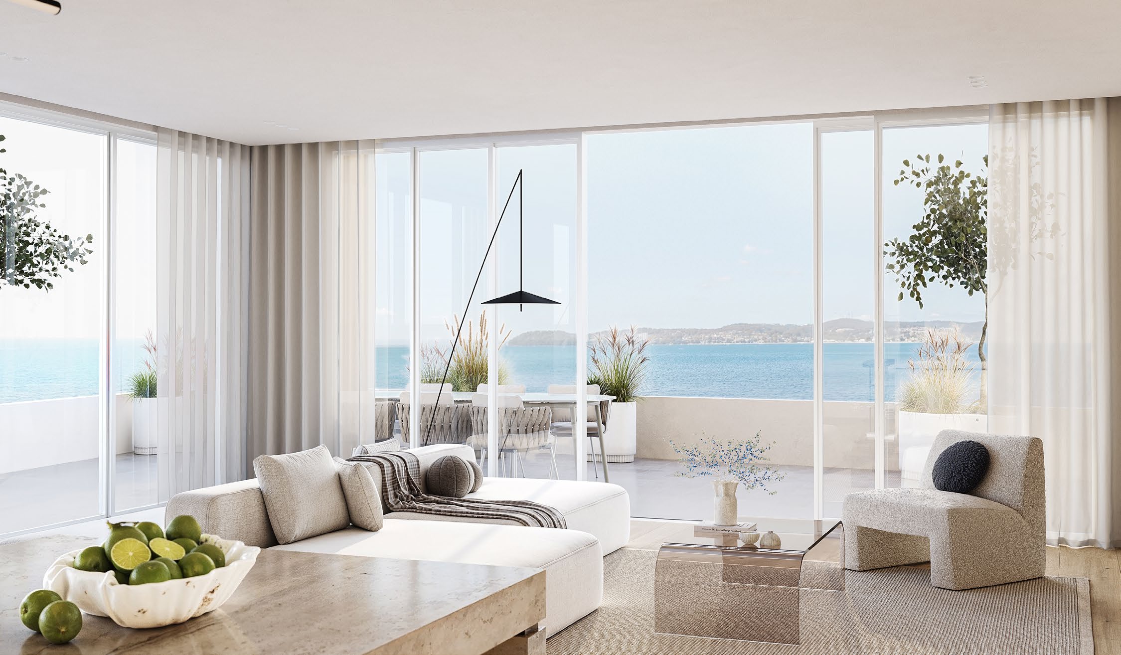 Open-plan living area at The Jewel opening onto a terrace with bay views